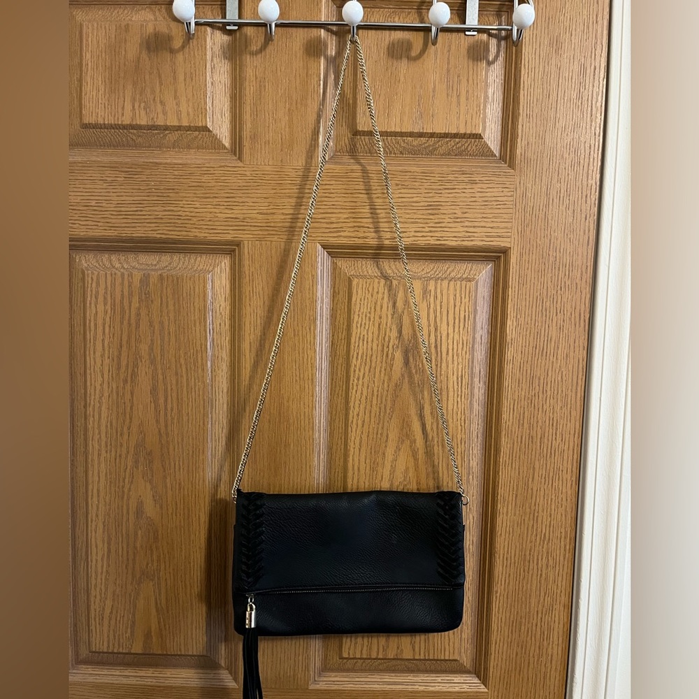 Black cross body purse with gold accents and braided detail